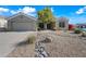 Well-maintained single-story home with desert landscaping and gravel front yard at 104 W Windsong Dr, Phoenix, AZ 85045