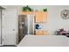 Bright kitchen includes a stainless steel refrigerator, wood cabinets, granite countertops, and a convenient beverage station at 104 W Windsong Dr, Phoenix, AZ 85045