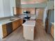 Well-equipped kitchen featuring stainless steel appliances, quartz countertops, central island and light wood cabinetry at 104 W Windsong Dr, Phoenix, AZ 85045