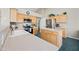 Modern kitchen with light wood cabinetry, stainless steel appliances, and tile flooring at 104 W Windsong Dr, Phoenix, AZ 85045