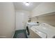 Laundry room with washer, dryer and shelving at 104 W Windsong Dr, Phoenix, AZ 85045