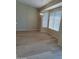 Bright living room featuring neutral tones, light wood flooring, modern lighting fixture, and lots of natural light at 104 W Windsong Dr, Phoenix, AZ 85045