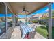 Covered patio featuring a dining table, built-in grill, and stunning views of the pool and beautifully landscaped backyard at 104 W Windsong Dr, Phoenix, AZ 85045