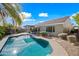 Inviting backyard pool surrounded by a patio and landscaping, perfect for outdoor relaxation and entertainment on a sunny day at 104 W Windsong Dr, Phoenix, AZ 85045