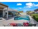 Backyard features a refreshing pool surrounded by a patio and mature landscaping for outdoor enjoyment and relaxation at 104 W Windsong Dr, Phoenix, AZ 85045