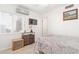 This bedroom features light hardwood floors, a mounted television, and a window view at 1107 E Villa Rita Dr, Phoenix, AZ 85022