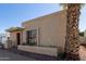 Exterior corner view of a tan home, featuring a palm tree and a red rock border around a garden bed at 1107 E Villa Rita Dr, Phoenix, AZ 85022