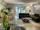 Bright living room featuring dark colored sectional sofa, modern lighting, and large windows at 1107 W Osborn Rd # 106, Phoenix, AZ 85013