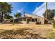View of backyard, enclosed patio, landscaping, and mature trees at 122 Leisure World --, Mesa, AZ 85206