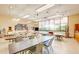 Bright craft room featuring tables, chairs, and natural light at 122 Leisure World --, Mesa, AZ 85206