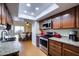 Updated kitchen with stainless appliances, granite counters, and an open view to the dining area at 122 Leisure World --, Mesa, AZ 85206