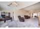 A large, open living space featuring neutral tones, plush carpeting, and natural lighting at 122 Leisure World --, Mesa, AZ 85206