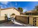 Relaxing patio area featuring chair, block wall, and decorative metal gate at 122 Leisure World --, Mesa, AZ 85206