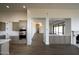 Gourmet kitchen with stainless steel appliances and adjacent to the dining room and fireplace at 12870 E Rosewood Dr, Scottsdale, AZ 85255