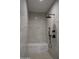 Modern shower with a built in bench, matte black fixtures, and neutral toned tile surround at 12870 E Rosewood Dr, Scottsdale, AZ 85255