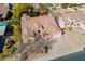 Aerial view of a well-maintained home with a tile roof, three-car garage, desert landscaping at 1310 S Vine Ct, Gilbert, AZ 85233