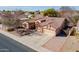 Aerial view of a well-maintained home with a tile roof, three-car garage, and desert landscaping at 1310 S Vine Ct, Gilbert, AZ 85233