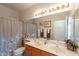 Bathroom featuring a double sink vanity, large mirror, and neutral color scheme at 1310 S Vine Ct, Gilbert, AZ 85233