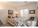 Bright bedroom with a twin size bed, natural light, and comfortable chair at 1310 S Vine Ct, Gilbert, AZ 85233