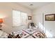 Inviting bedroom with a plush chair, soft lighting, and a comfortable quilt-covered bed at 1310 S Vine Ct, Gilbert, AZ 85233