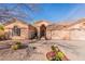 Charming single-story home featuring desert landscaping, a barrel tile roof, and a two-car garage at 1310 S Vine Ct, Gilbert, AZ 85233