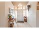 Bright foyer with a high ceiling, white tile floors, and decorative accents creates a welcoming entrance at 1310 S Vine Ct, Gilbert, AZ 85233