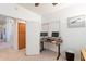 Bright home office with standing desk, dual monitors, and built-in storage for optimal work from home experience at 1310 S Vine Ct, Gilbert, AZ 85233