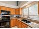Well-lit kitchen features granite countertops, stainless steel appliances, and modern fixtures at 1310 S Vine Ct, Gilbert, AZ 85233