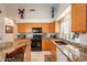 Functional kitchen with granite countertops, stainless steel appliances, and plenty of cabinet storage space at 1310 S Vine Ct, Gilbert, AZ 85233