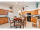 Well-appointed kitchen with granite countertops, wood cabinets, and a central island with seating at 1310 S Vine Ct, Gilbert, AZ 85233