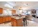 Well-designed kitchen with granite countertops, an island with bar seating, and a view of the living room at 1310 S Vine Ct, Gilbert, AZ 85233