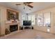 Spacious living room with a fireplace, large windows, and neutral tones, creating a cozy and welcoming ambiance at 1310 S Vine Ct, Gilbert, AZ 85233