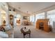 Spacious living room featuring a large window, comfortable seating, and a dining area at 1310 S Vine Ct, Gilbert, AZ 85233