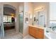 Well-lit main bathroom featuring a walk-in shower, bathtub, and vanity at 1310 S Vine Ct, Gilbert, AZ 85233