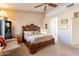 Relaxing main bedroom with a large bed, soft lighting, and an ensuite bathroom at 1310 S Vine Ct, Gilbert, AZ 85233