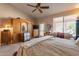 Comfortable main bedroom with a ceiling fan and plenty of room for seating at 1310 S Vine Ct, Gilbert, AZ 85233