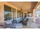 Inviting covered patio featuring comfortable seating, a fire pit table, and stylish decor at 1310 S Vine Ct, Gilbert, AZ 85233