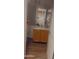 Cozy bathroom with wood-look tile flooring, wooden vanity and modern fixtures at 13820 S 41St Way, Phoenix, AZ 85044