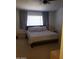 Bedroom with soft gray carpet features a plush bed with ample pillows and a chair at 13820 S 41St Way, Phoenix, AZ 85044