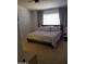 Calming bedroom features soft carpeting, a ceiling fan, neutral decor, and a large window at 13820 S 41St Way, Phoenix, AZ 85044