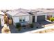 Aerial view of single-story home showing nice roof, desert landscaping, and two-car garage at 14177 W Calle Lejos --, Surprise, AZ 85387