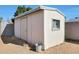 Exterior view of the storage shed with a window, door, and light blue trim at 14637 N 36Th Dr, Phoenix, AZ 85053