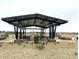 Open-air picnic area with stylish metal roof and multiple tables, a perfect community gathering spot at 15749 W Beryl Ave, Waddell, AZ 85355