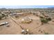 Aerial view showcasing desert home with a large yard, complemented by a tranquil desert scenery at 1600 W Ivar Rd, San Tan Valley, AZ 85144