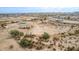 Serene aerial view of a neutral-toned desert home in a peaceful area, revealing the generous surrounding land at 1600 W Ivar Rd, San Tan Valley, AZ 85144
