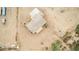 Aerial view of desert home with covered porch, concrete driveway, desert landscaping and fenced yard at 1600 W Ivar Rd, San Tan Valley, AZ 85144