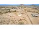 Wide aerial view of a desert home showing its proximity to mountains and other homes in the distance at 1600 W Ivar Rd, San Tan Valley, AZ 85144