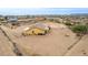 Desert home featuring an expansive fenced-in yard with a covered porch, trash receptacle area and a mountain view at 1600 W Ivar Rd, San Tan Valley, AZ 85144
