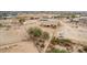 A captivating aerial view of a single-story home with a neutral palette surrounded by desert landscape at 1600 W Ivar Rd, San Tan Valley, AZ 85144
