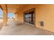 Covered back patio with concrete floor and tan stucco wall at 1600 W Ivar Rd, San Tan Valley, AZ 85144